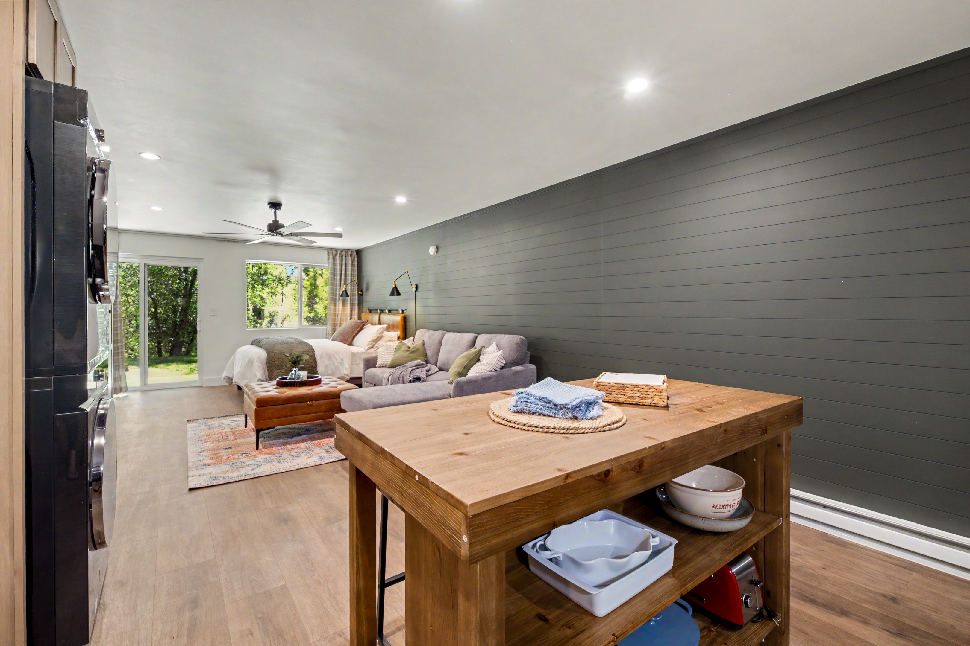 Studio interior overview with kitchen island and bed