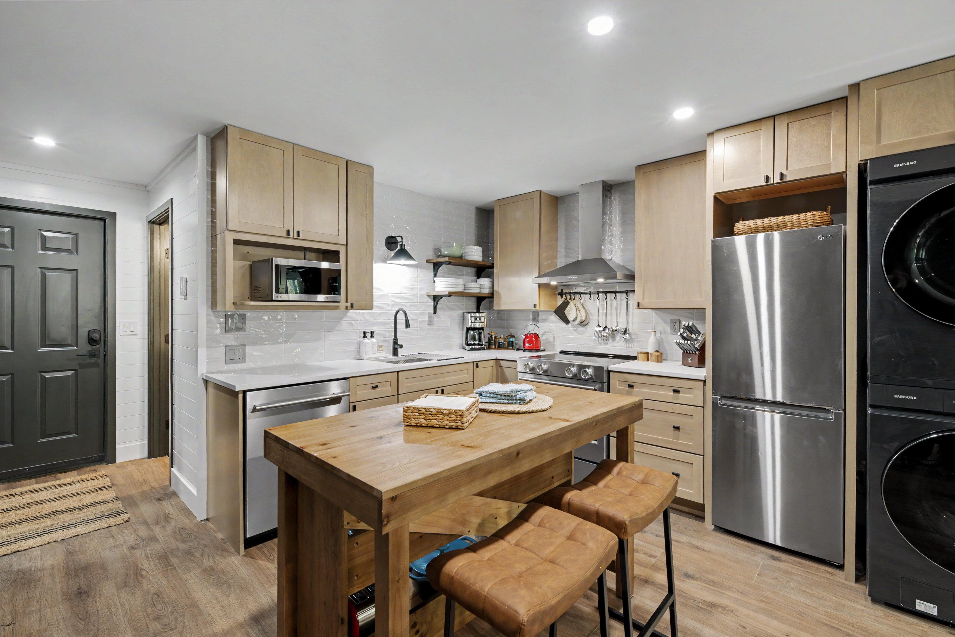Kitchen with butcher block island and bar stools