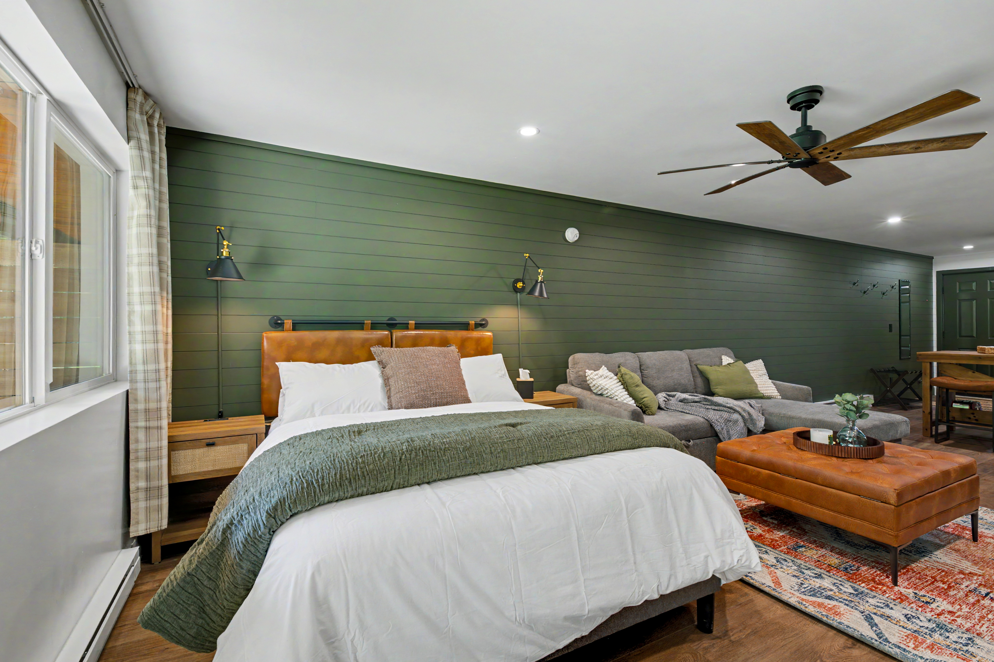 Bedroom with green accent wall and patio doors