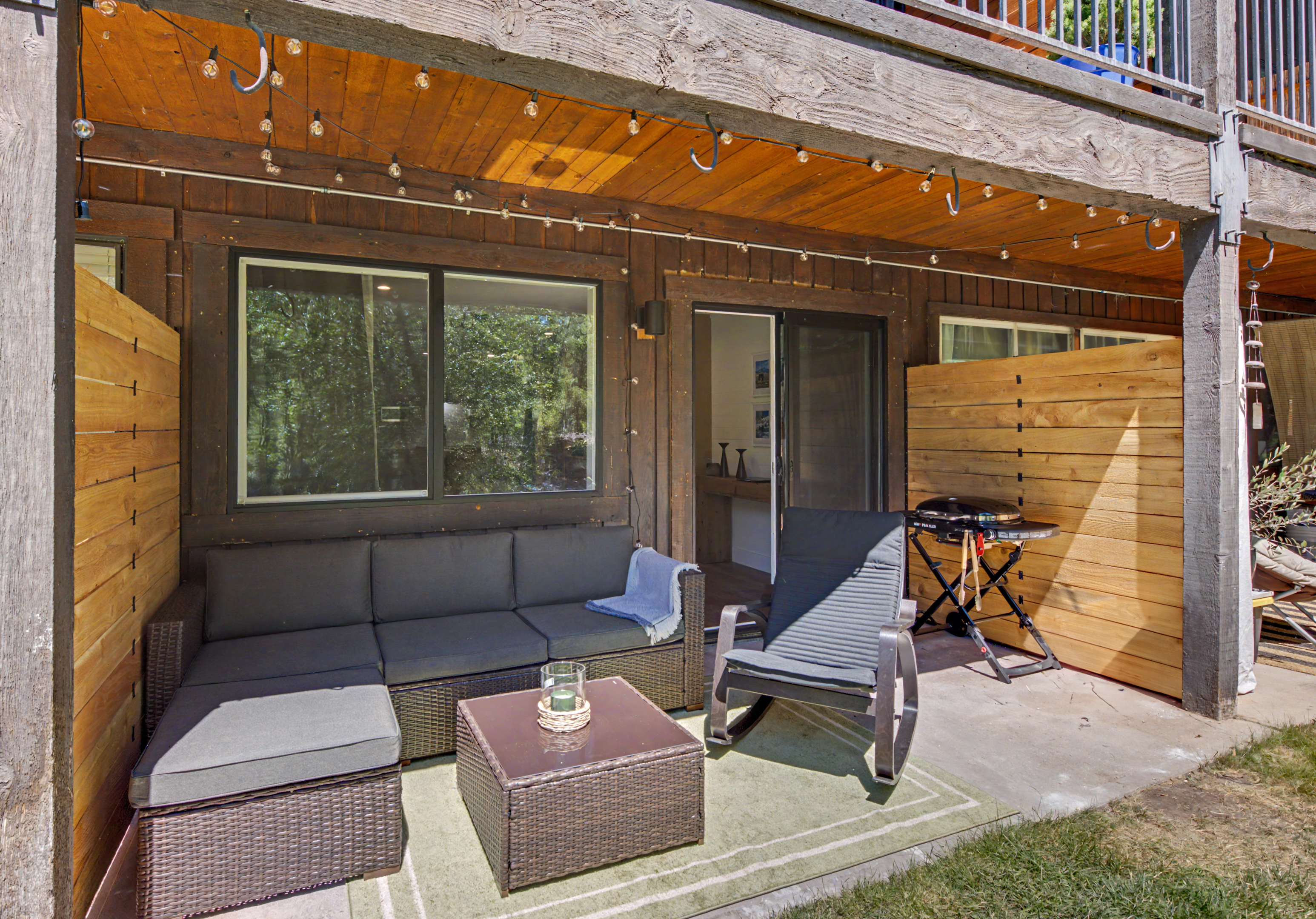 Private patio with sectional and grill